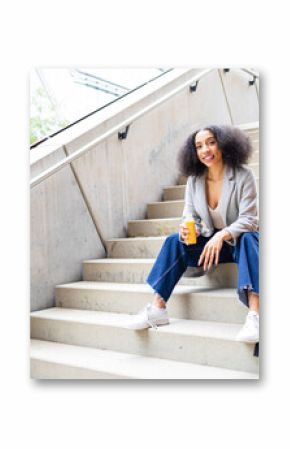 Young ethnic woman having a break sitting on stairs