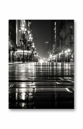 A black and white photo of a city street at night. Perfect for urban and night photography projects