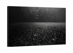 A black and white photo of a street at night. Suitable for urban and nightlife concepts