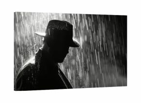 dramatic silhouette of a dangerous man in a hat at night in the rain in the city in the old crime.
