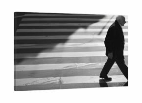 A person walking at a busy street intersection