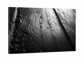 A black and white photo of a wet street at night, perfect for use in crime or thriller scene