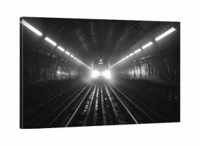 black and white photography in the london tube network and high contrast dramatic lighting .