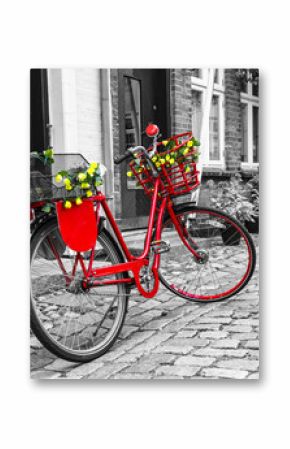 Retro vintage red bicycle on cobblestone street in the old town.