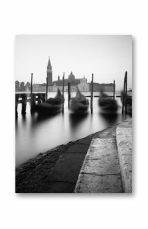 Venice classic view with gondolas on the waves