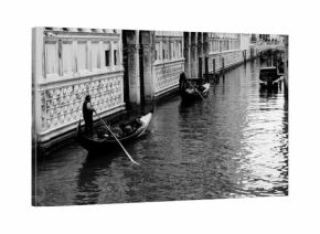 Black and white photo of gondola and gondolier taken in the beautiful city of Venice, Italy