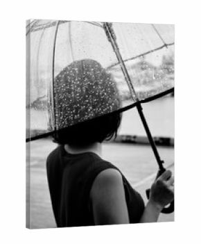 Black and white shot of a woman with a umbrella