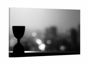 Black and white trophy with blurred city background, symbolizing success and achievement, monochrome sports award concept