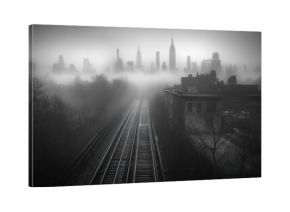A misty cityscape with train tracks leading to the horizon.