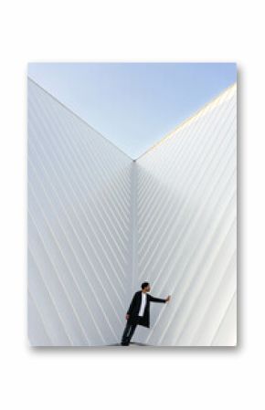Man leaning against minimalist metallic wall