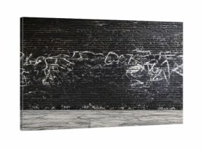 Desolate black brick wall with white graffiti showcasing a dilapidated urban feel and ample empty space for text or graphic overlay