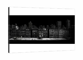 Black and white photograph of a cityscape at night, with bright lights and bustling streets