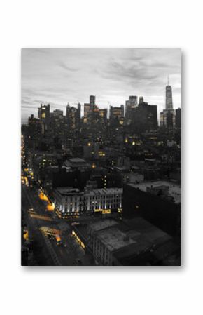 Yellow lights of the New York City skyline shining against a black and white cityscape in Manhattan NYC