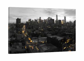 Yellow lights of the New York City skyline shining against a black and white cityscape in Manhattan NYC