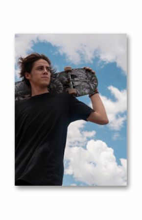 Young guy in a black t-shirt posing with his skateboard on his shoulders