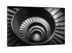 A spiral staircase with black and white steps