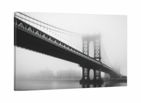 A bridge over a river with fog in the background