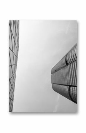 Glass surface of skyscrapers view in district of business centers with reflection on it, black and white