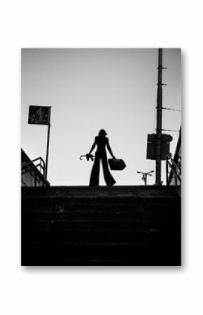 Fashion art portrait of elegant girl in geometric. Black and white photo of stylish young woman in cityscape