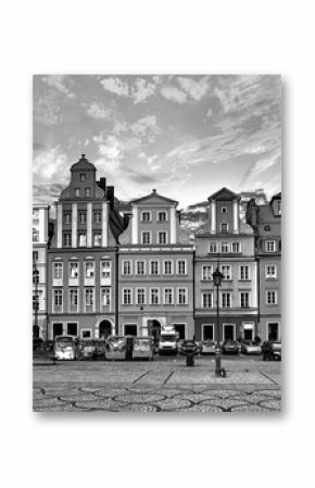 Central market square in Wroclaw Poland with old houses, street lamp and walking tourists people at gorgeous stunning evening sunset sunshine. Travel vacation concept. Black and white