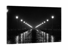 black and white pier at night in the rain