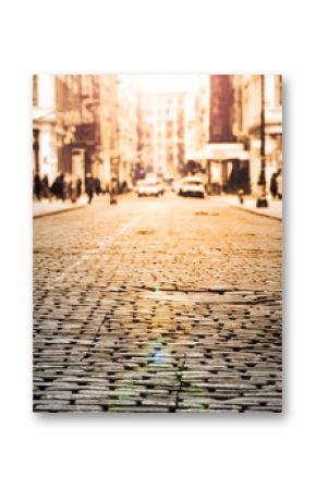 New York City - Cobblestone street view in Soho with sunlight background in black and white