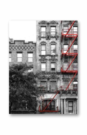 Red fire escape on the exterior of an old building in black and white - Manhattan, New York City