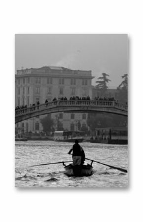 Venice, Italy, December 28, 2018 evocative black and white image of gondolas moving in a canal