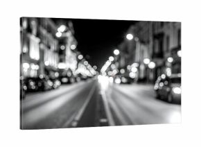 Night city street scene with blurred lights and cars, black and white
