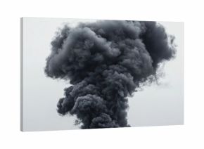 Dramatic black smoke rising against a grey white background conveying a sense of fire explosion or industrial accident in an urban environment