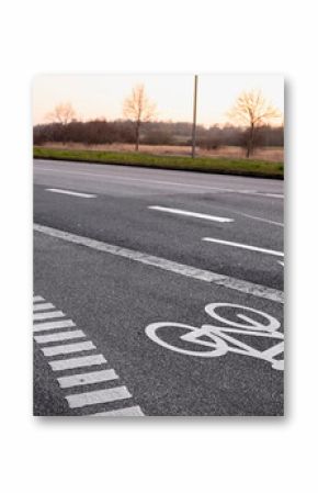 White bike lane symbols with directional arrows painted on black asphalt road, representing safe cycling paths, guidance, and city traffic infrastructure.
