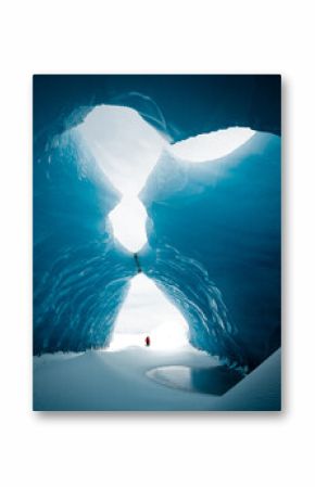 Person is standing in beautiful ice cave  in Vatnajökull glacier Iceland in the winter