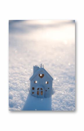 Winter solstice in snowy forest or park natural scene. Hibernal solstice. Toy house and Sparkling snow in the snowy forest and low sun