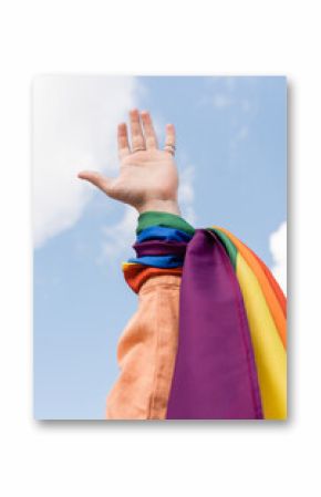 Cropped view of gay man with lgbt flag on hand and sky at background outdoors, International day against homophobia.