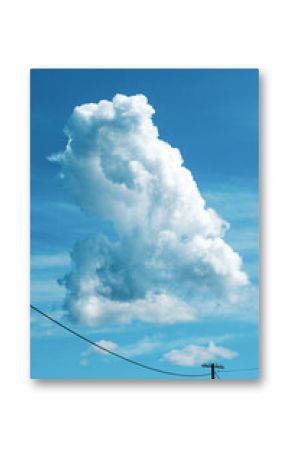 Huge white cloud at the sky, over the old wooden electricity post and wires