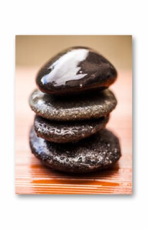 Stones, zen and wet rocks for hot stone massage at a spa for luxury and wellness. Peace, closeup and rock balance with tranquility and feng shui for meditation, holistic therapy and water on pile