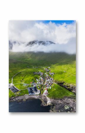 Drone view of Village of Gjogv on Faroe Islands with colourful houses. Mountain landscape with ocean coast