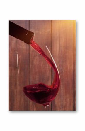 red wine in glass with bottle on wooden boards