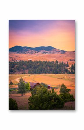 Helena Suburb Sunrise Skyline on the Mountain Dirtroad in Montana, USA: Tranquil downhill mountain valley summer landscape with warm glow