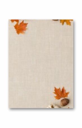 Vibrant autumn leaves in shades of orange and yellow placed artistically around a white wooden background