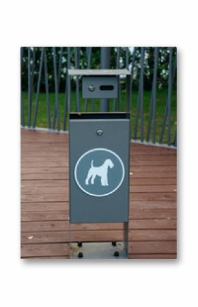 container for dog excrement in the park, close-up. place for walking dog in park. trash can with dog pattern. urban environment development