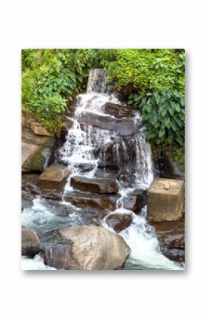 A waterfall is flowing down a rocky hillside