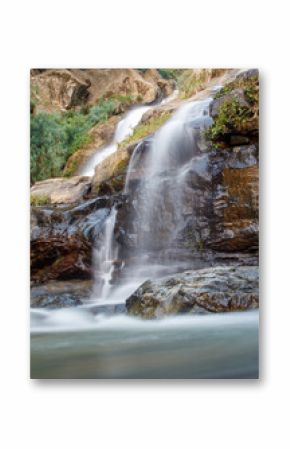 A waterfall is flowing down a rocky cliff