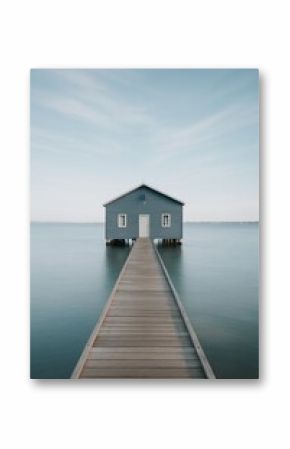 Wooden House on a Pier Overlooking Calm Water Under Clear Skies at Dawn
