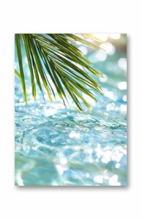 Peaceful scene featuring palm leaves over calm blue water, perfect for relaxation and nature themes.