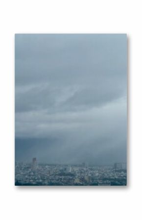 Gloomy cityscape under a dark stormy sky. Aerial view of a city on a rainy day with heavy clouds. Dramatic weather over an urban landscape.