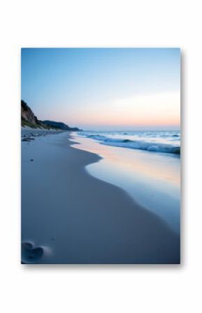 serene beach scene dawn cool blue white gradient sky reflecting calm waters shot low angle shallow depth