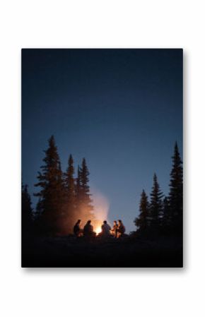 Group of friends around a campfire under a starry night sky. Evokes feelings of camaraderie, warmth, and adventure. Ideal for travel, friendship, or naturerelated content.