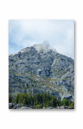 Majestic mountain peak with lush greenery and cloudy sky