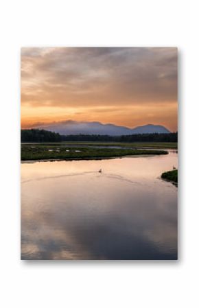 Sunset in Arcadia, Maine USA over a river and mountain landscape.